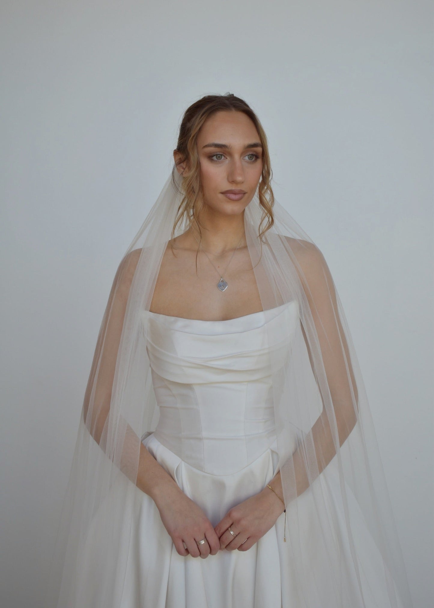 Bride wearing tulle veil in cathedral length