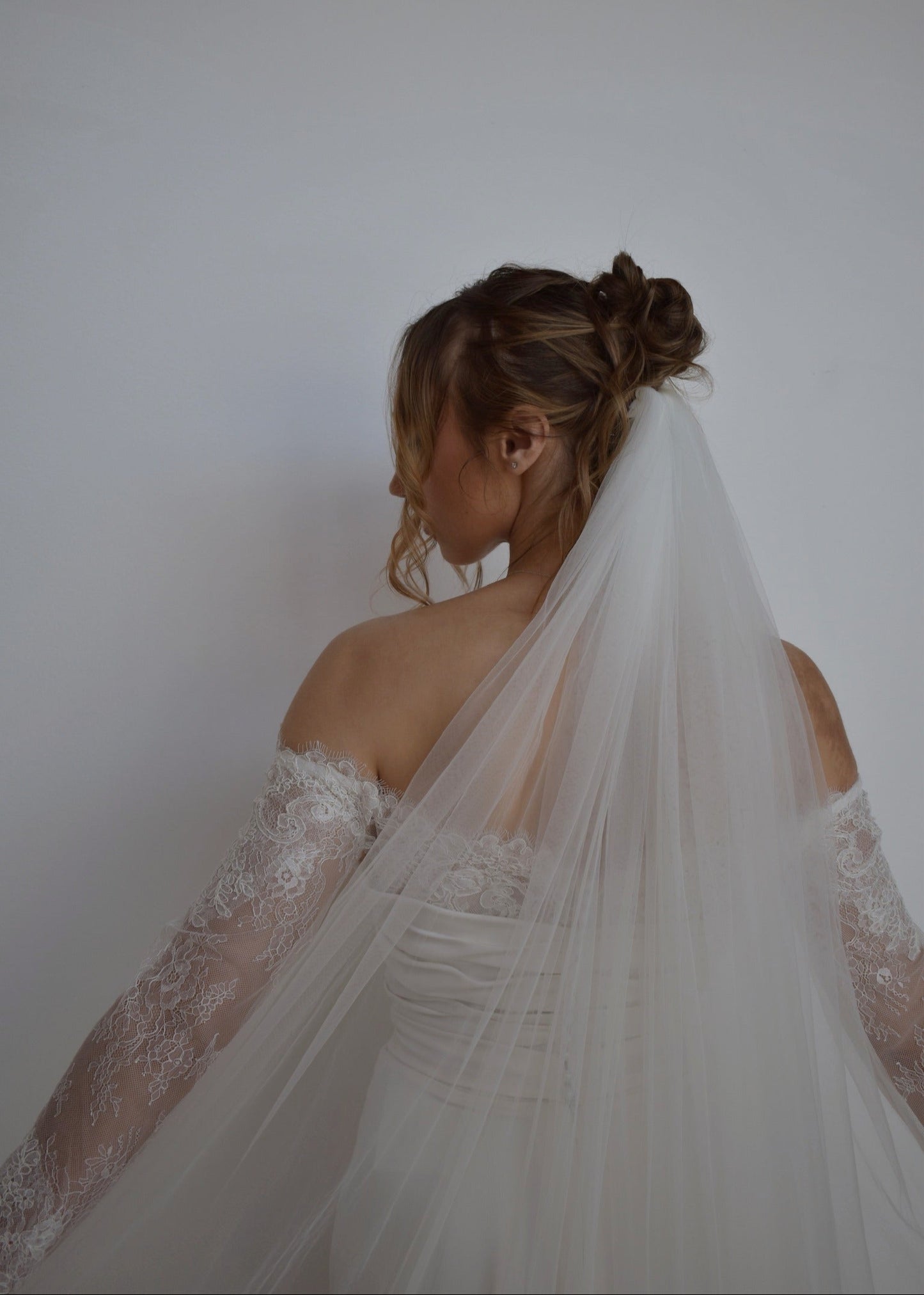Close up of cathedral length tulle veil on bride