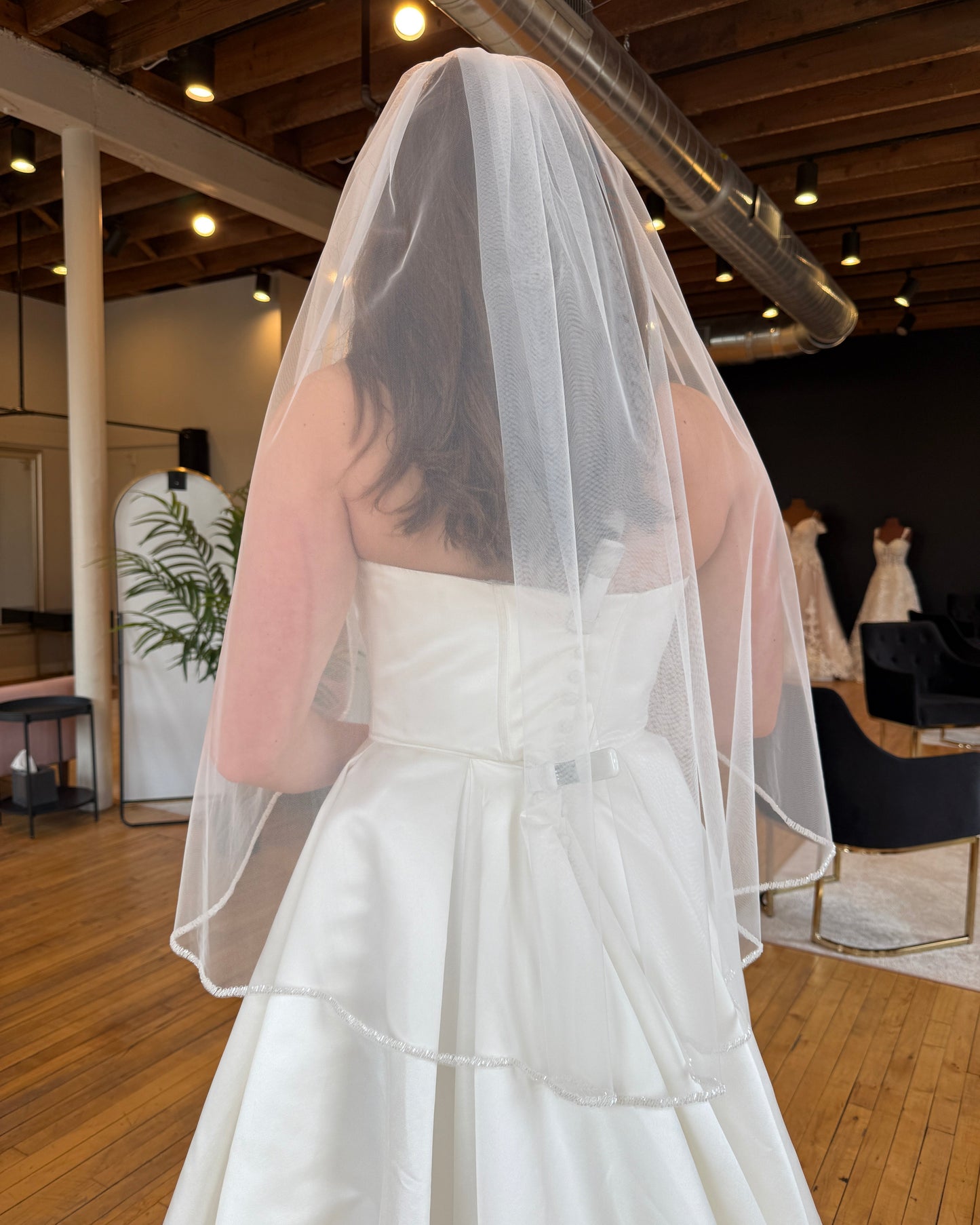 bride trying on fingertip veil