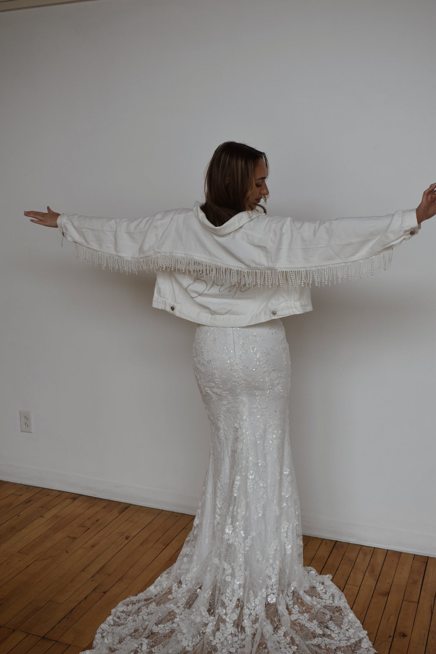 white pearl fringe jean jacket with wedding dress on bride