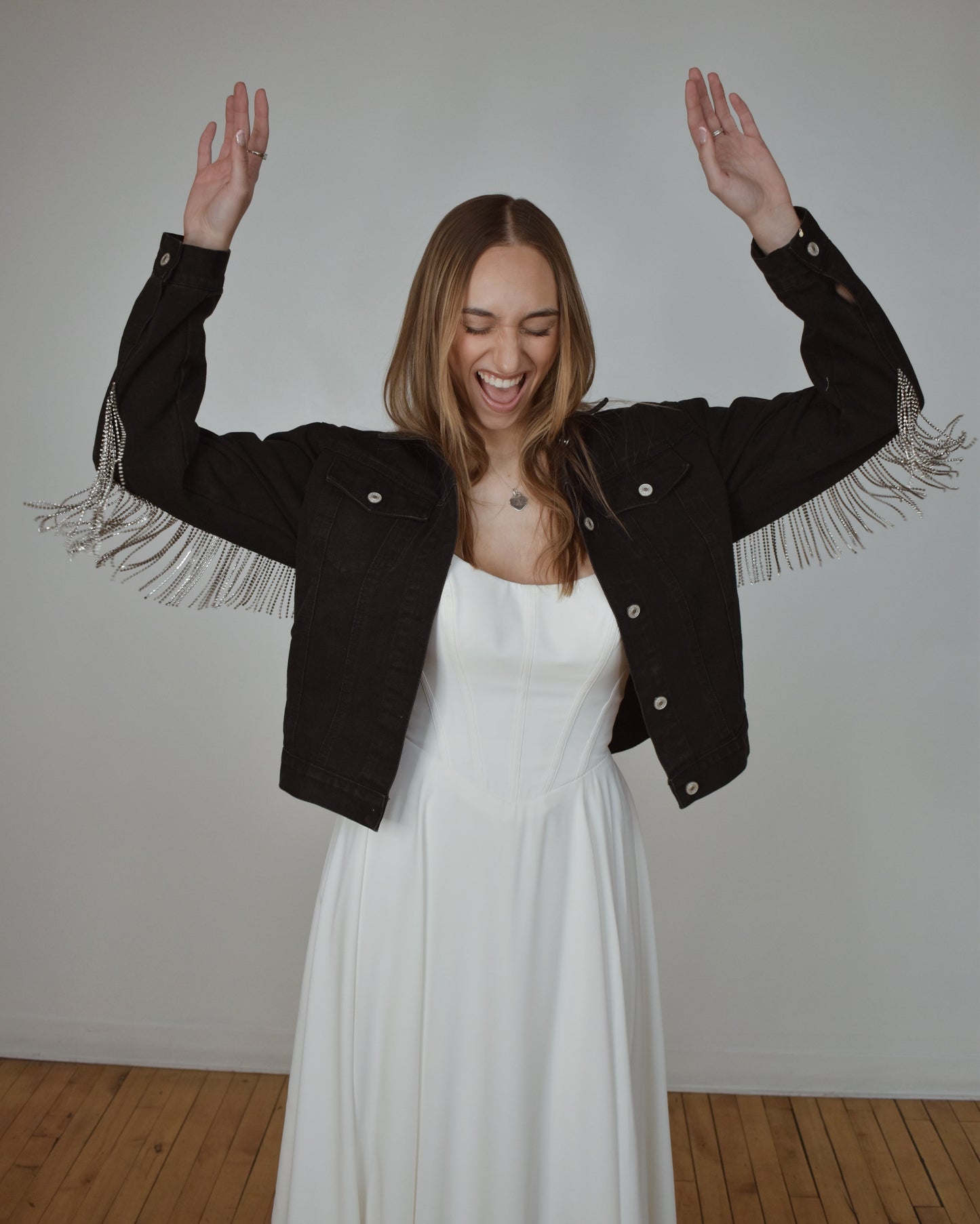 bride celebrating in black denim bridal jacket