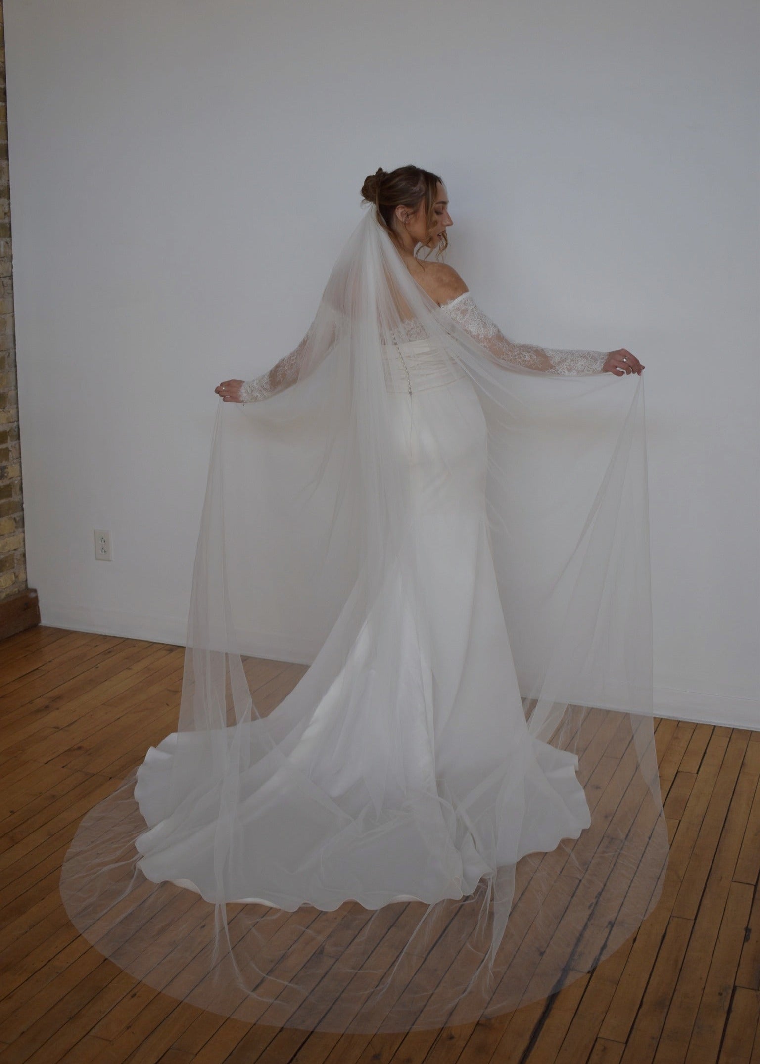 cathedral length tulle veil on fitted lace wedding dress