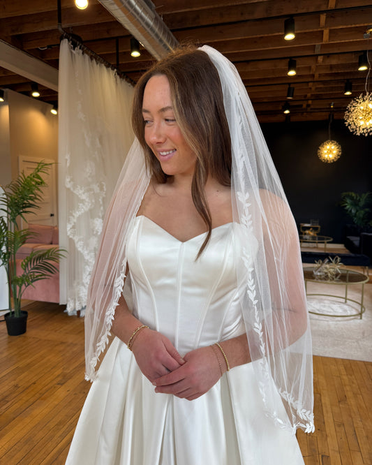 Bride wearing veil with leafy details