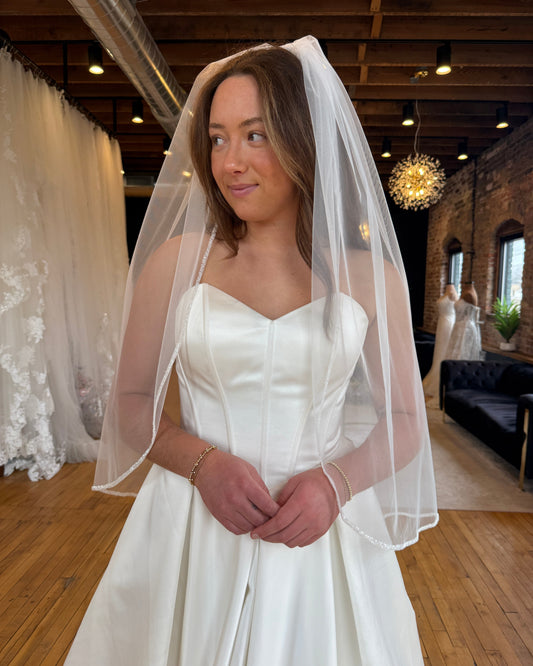 Bride wearing beaded veil from the front