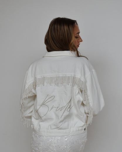 bride wearing white pearl fringe jean jacket