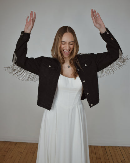 bride celebrating in black denim bridal jacket